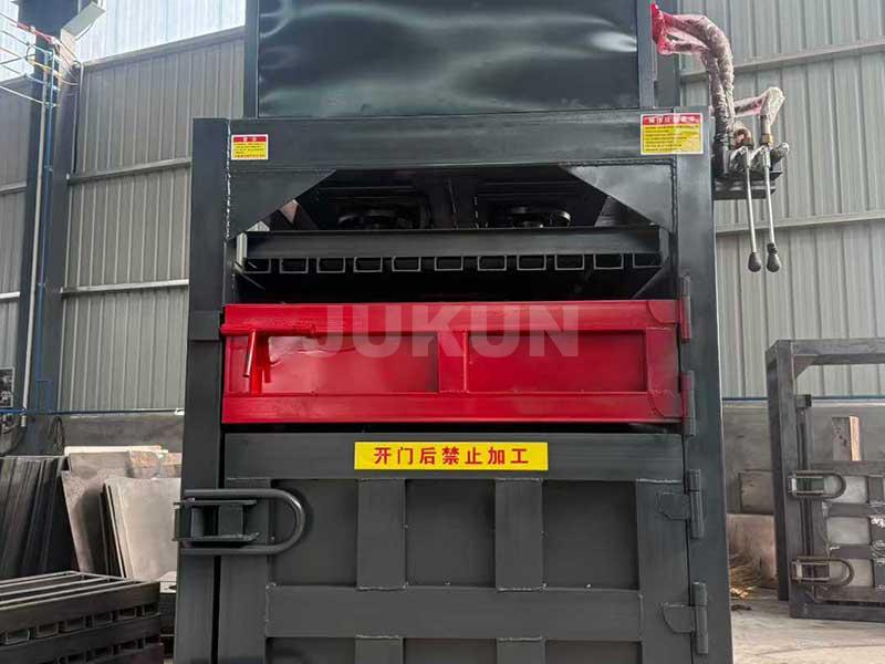 Baler machine compressing materials