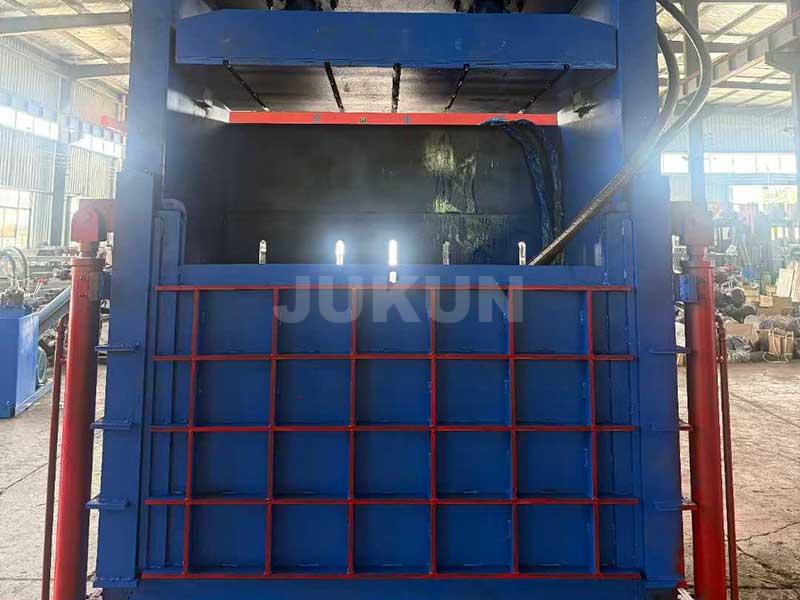 Two-ram textile baler in action